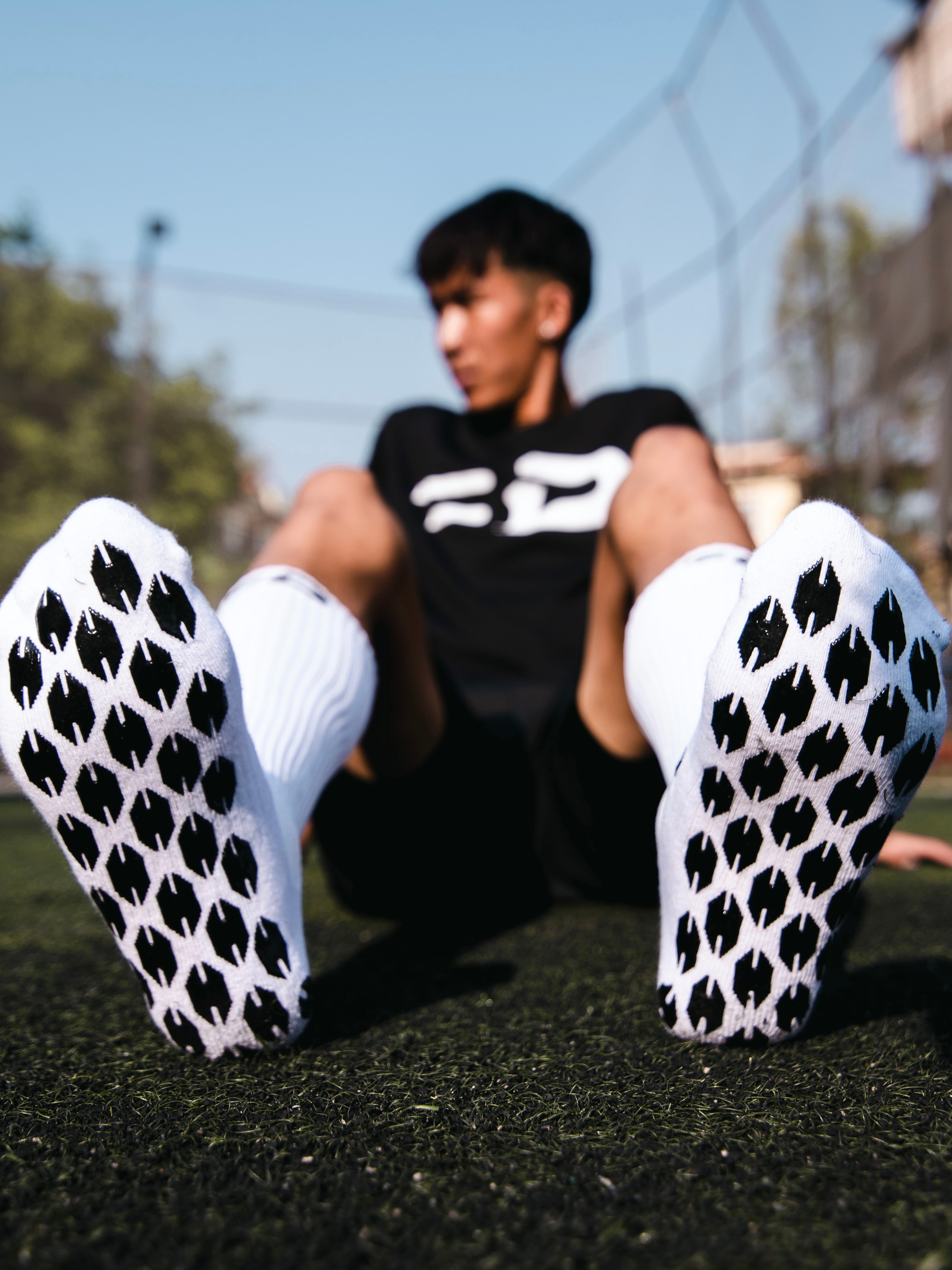 Soles of Ball Driven grip socks showing the Dhaka-inspired grip pattern